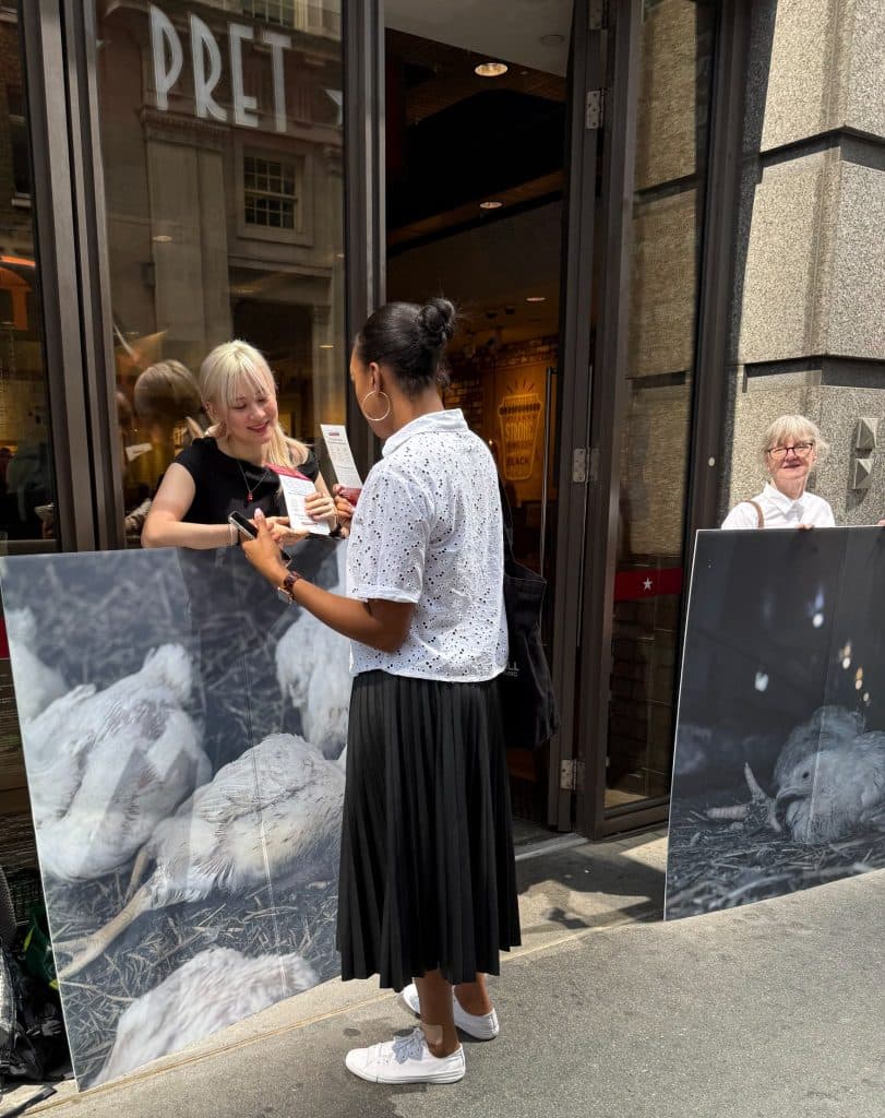 Jessica speaking to a member of the public outside a Pret cafe