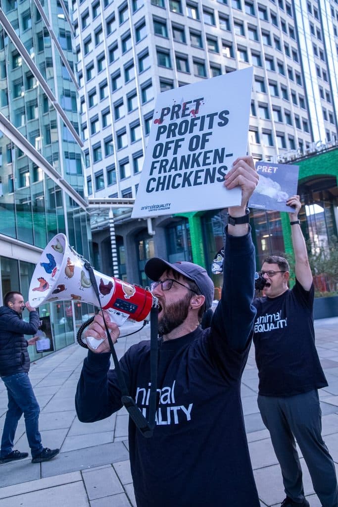 Animal Equality campaigners chanting into megaphones