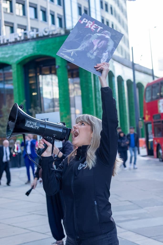 Campaigner holding frankenchicken poster outside Pret HQ